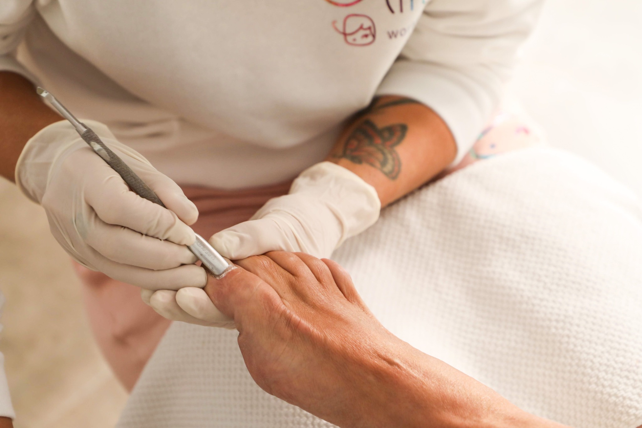 Clinician providing careful nail treatment